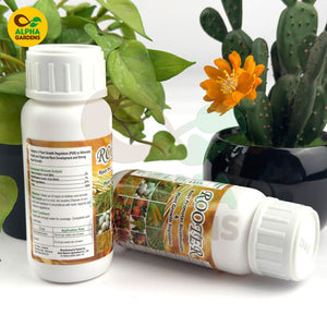 Two bottles of Root Stimulator with plants in the background