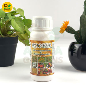 Bottle of 'Rooter' plant growth regulator with plants in the background