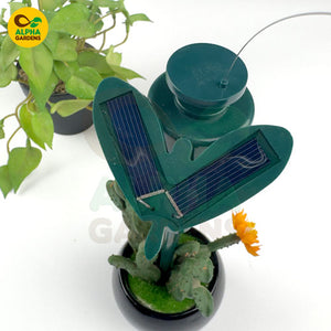 Solar-powered plant waterer with solar panels on a white 