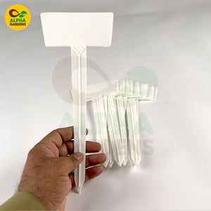 Hand holding a white LED light fixture against a white background with Alpha Gardens logo.